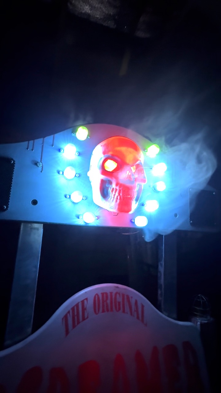 Close-up of the Screamer skull with blue lights, glowing red eyes and smoke