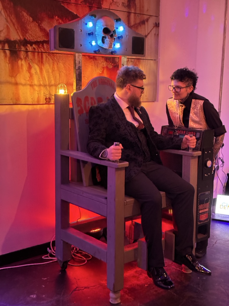 Player holding both handles of the Screamer while a friend watches