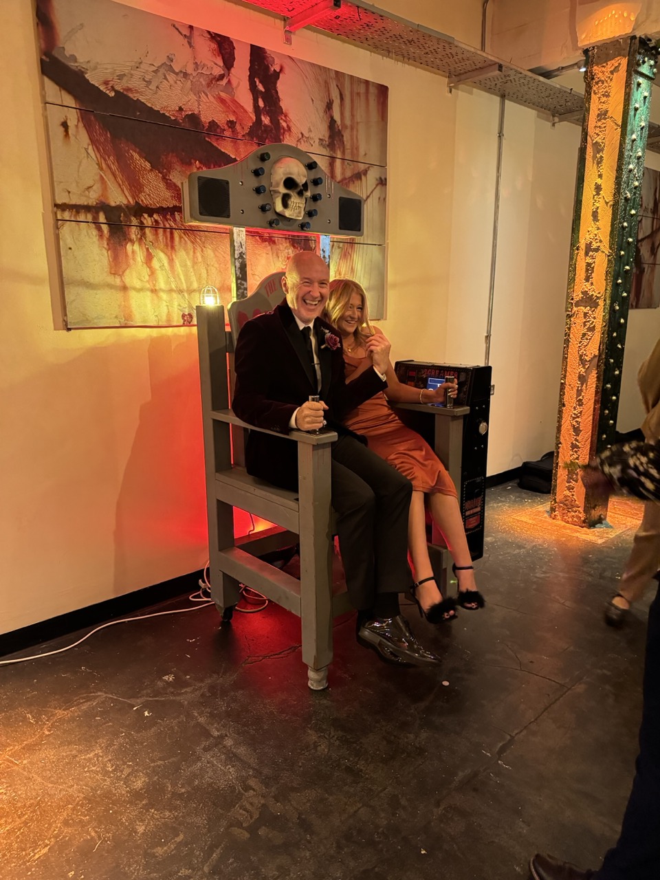 Two guests laughing together on the Screamer shock chair